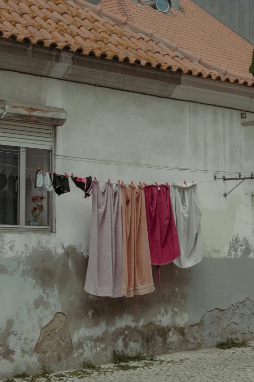 drying clothes on a rope outside of an old building