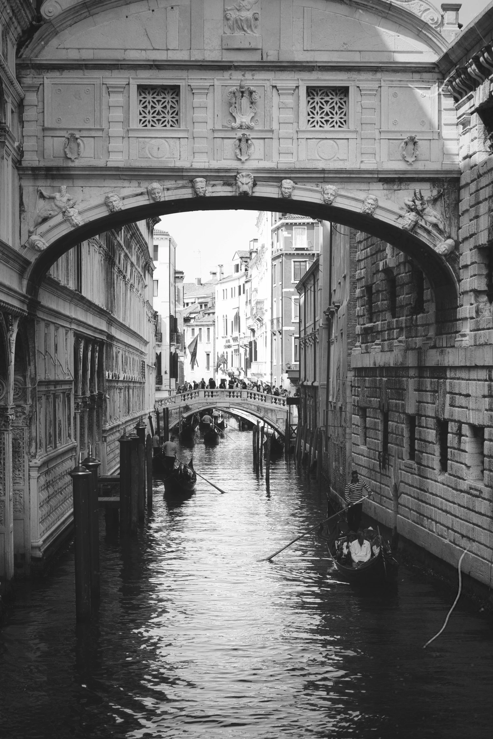 a black and white po of an arched bridge over the water