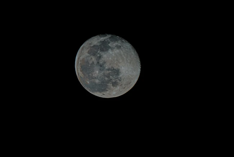 the full moon as seen from the top of the hill