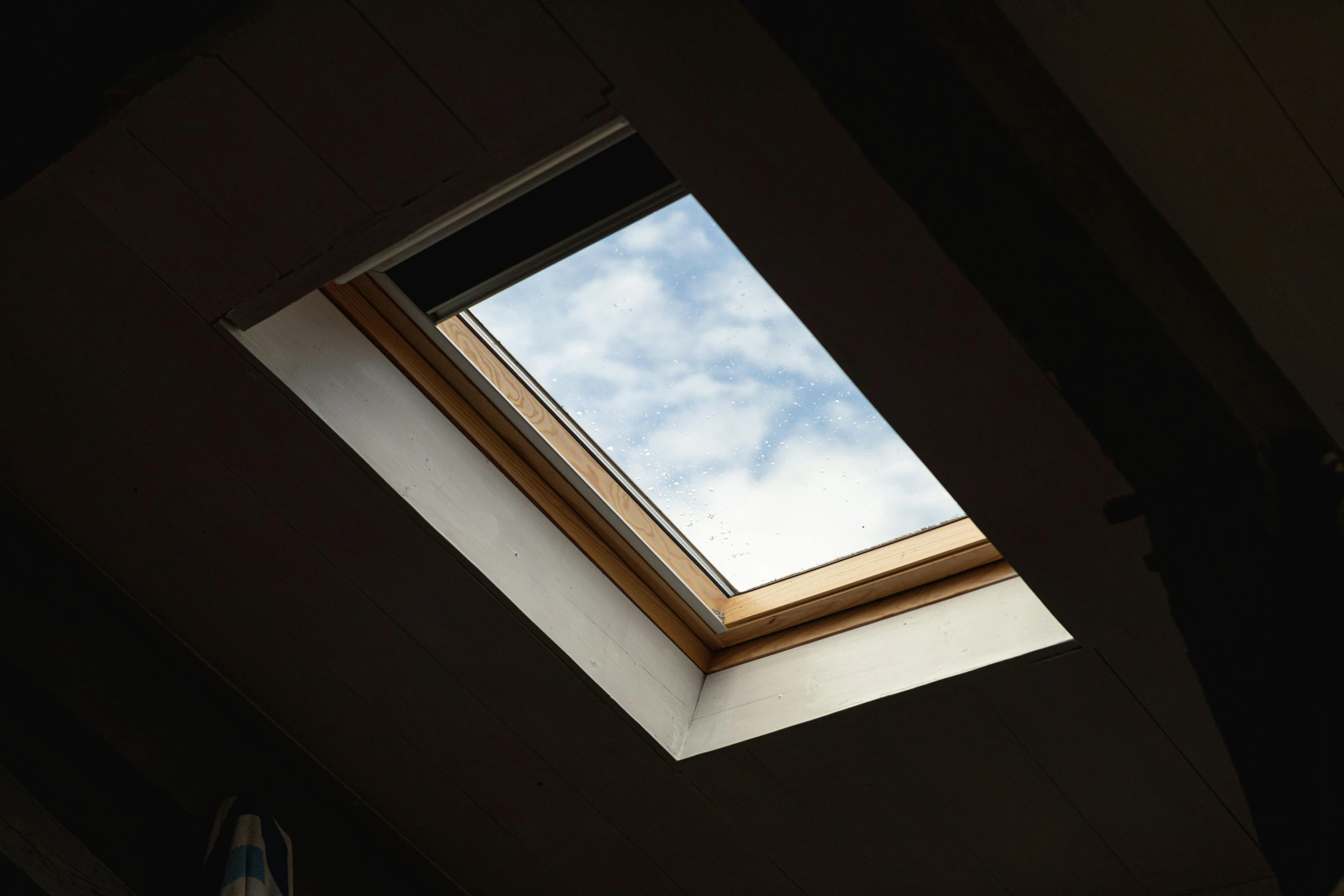 a skylight is shining into a bedroom