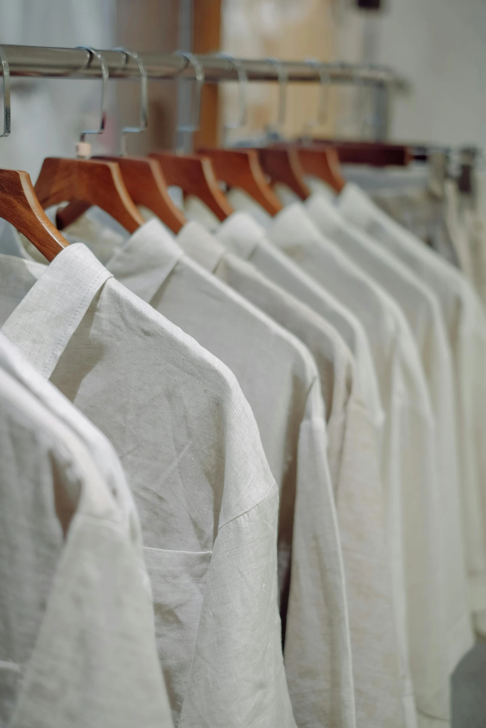 a rack of t shirts in white and tan