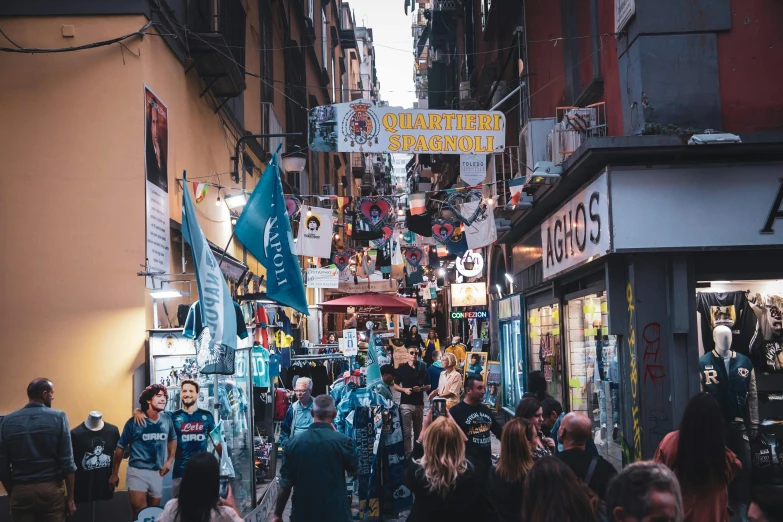 people walking down a busy street in a shopping district