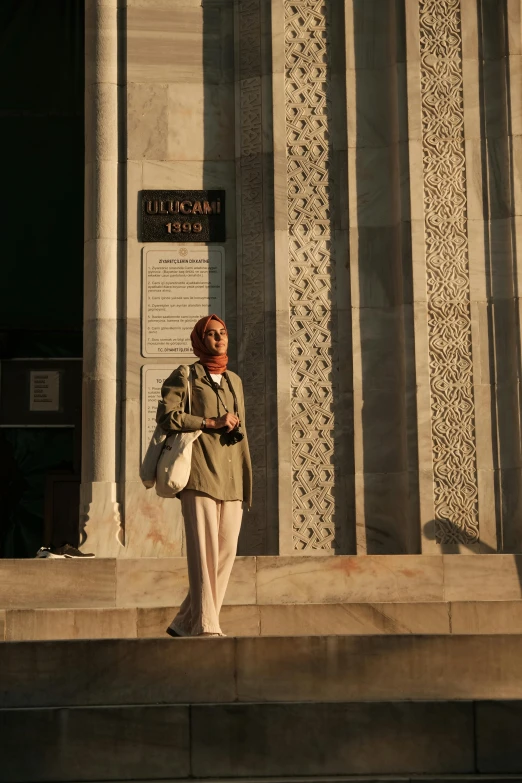 a woman is standing in front of a building