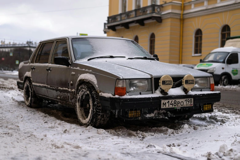 car is parked on the side of the road in heavy snow