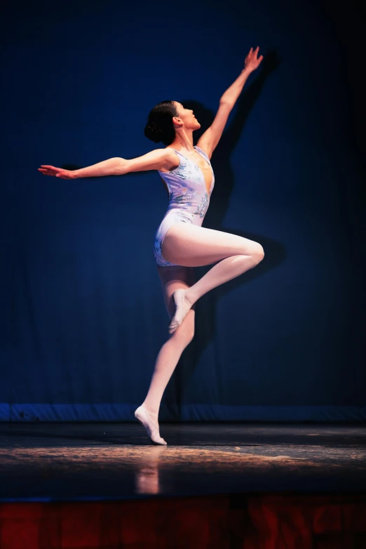a dancer dressed in white is posing for the camera
