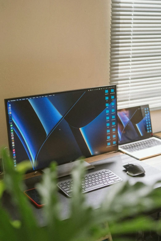 the laptop is set next to the computer screen