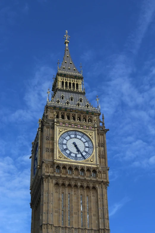 a very tall clock tower towering over a blue sky