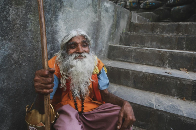 an old man sitting down on steps smoking a cigarette