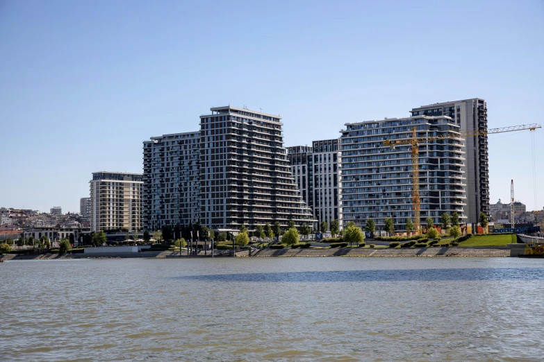 a large body of water sitting in front of some tall buildings