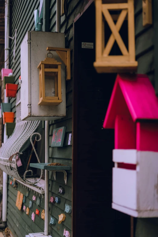 small wooden birdhouses hanging from the side of a building