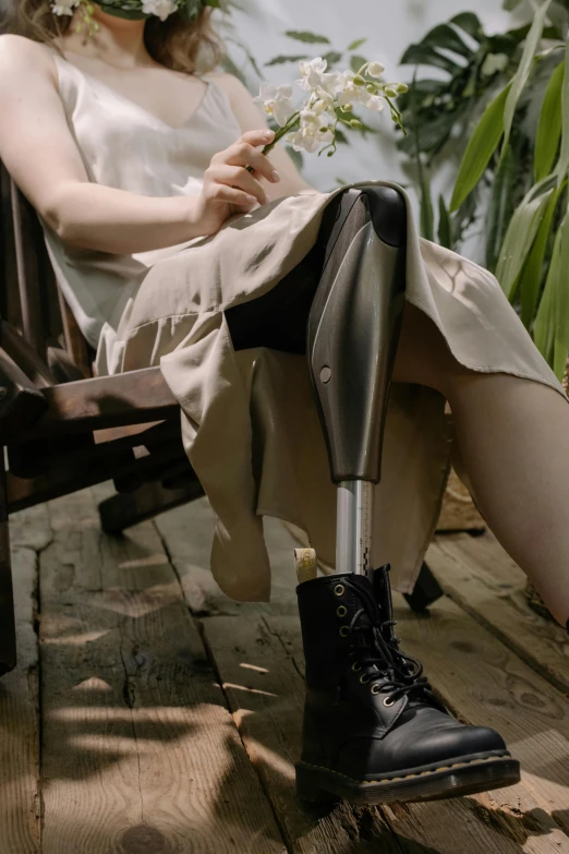 a woman in white dress and hat sitting down on a bench