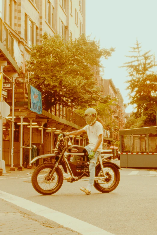 a person is standing on the street while holding his motorcycle
