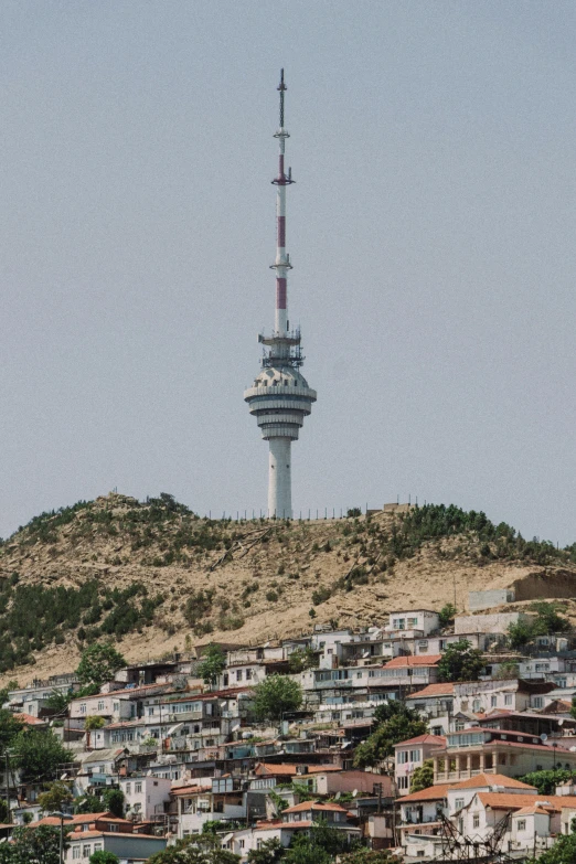 a very tall tower on top of a hill