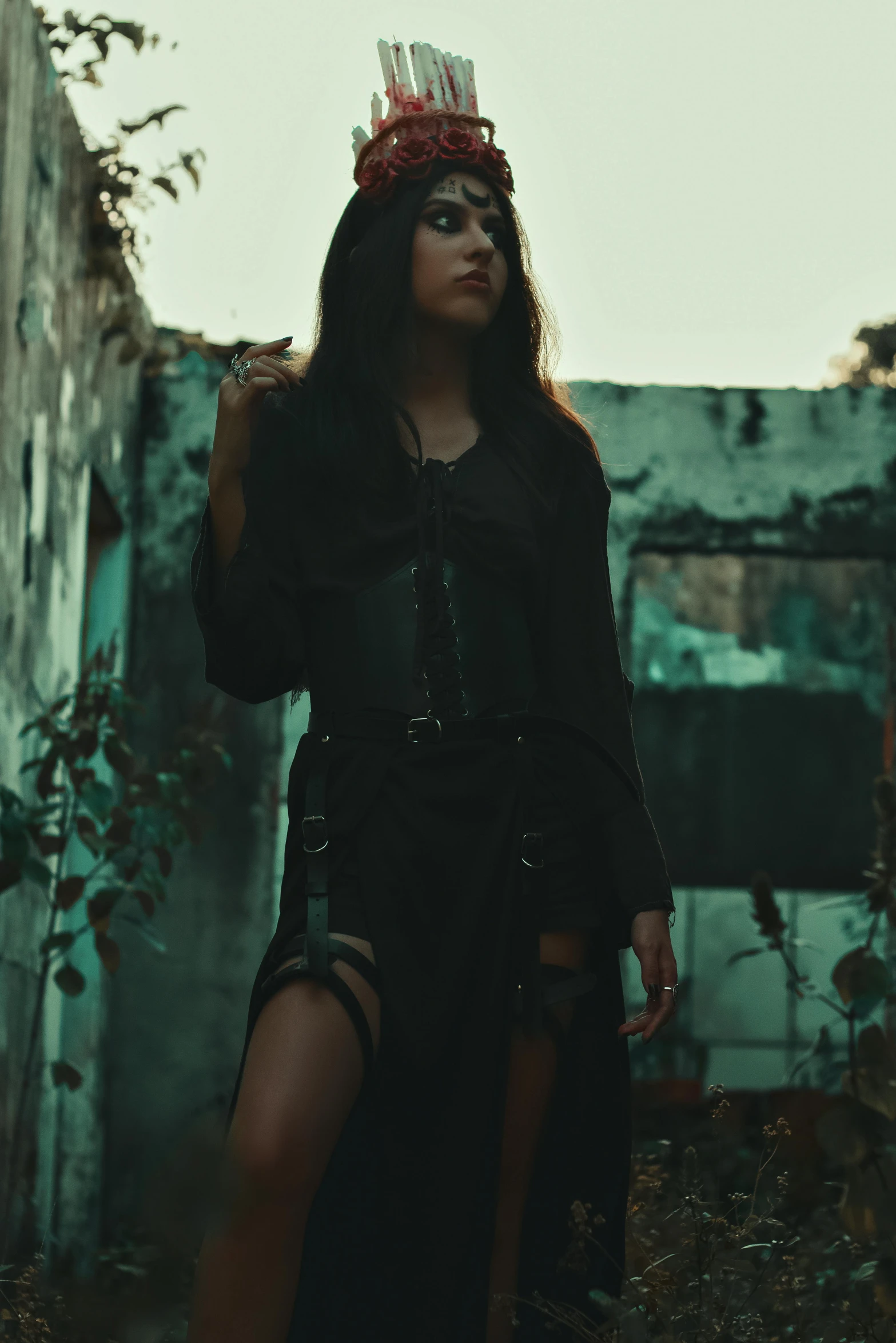 a young woman dressed in black posing outdoors