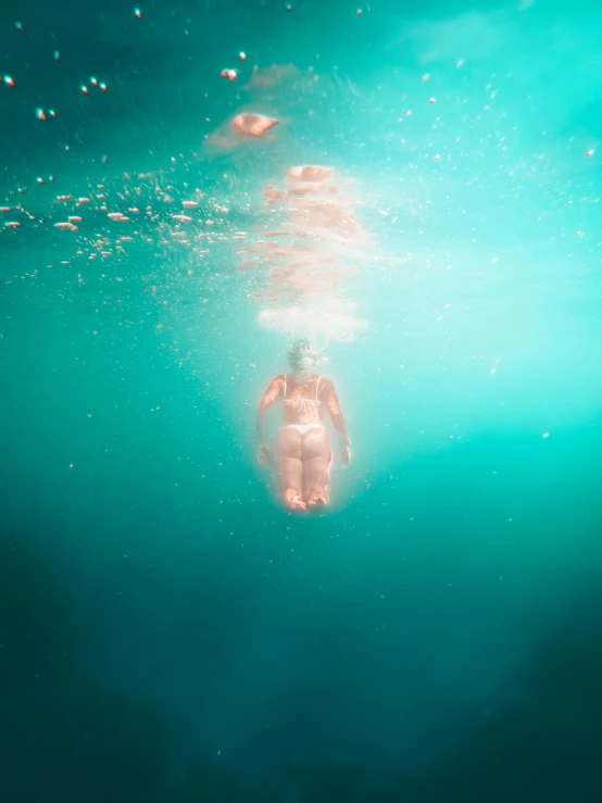 a person in the water and some bubbles