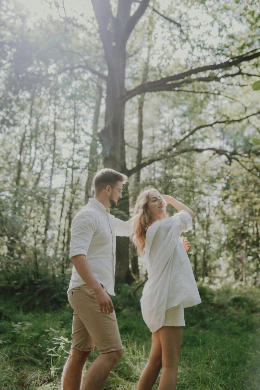 an image of a man and woman that are in the woods