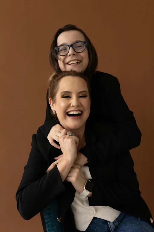 two people posing for a po and holding the same woman on top of her head