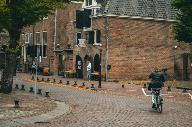 a person riding a bike down a brick road