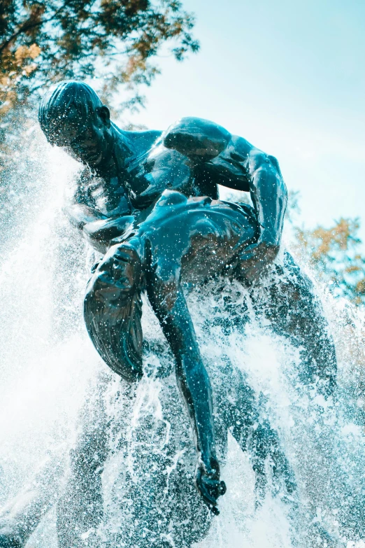 a man riding on top of a water slide