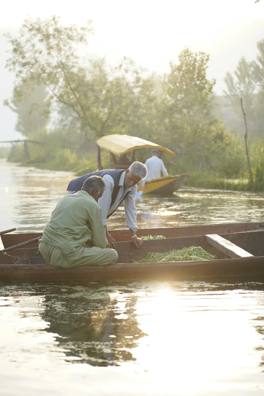 a group of men riding on the back of a small boat