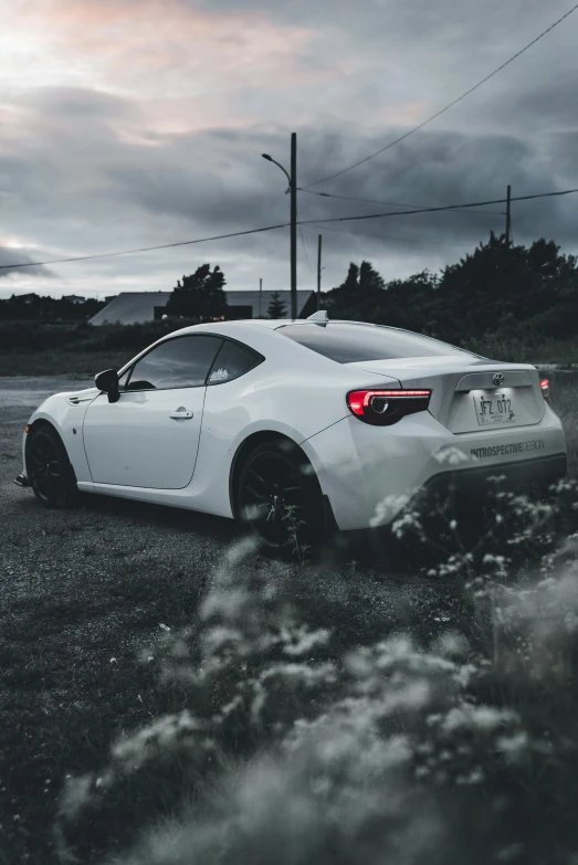 a white sports car parked on the side of the road