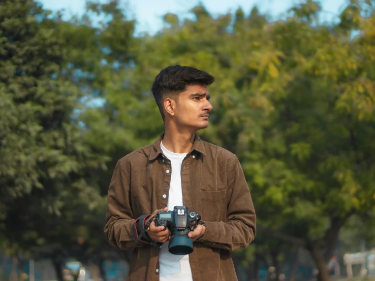 a man holding several cameras in his hand