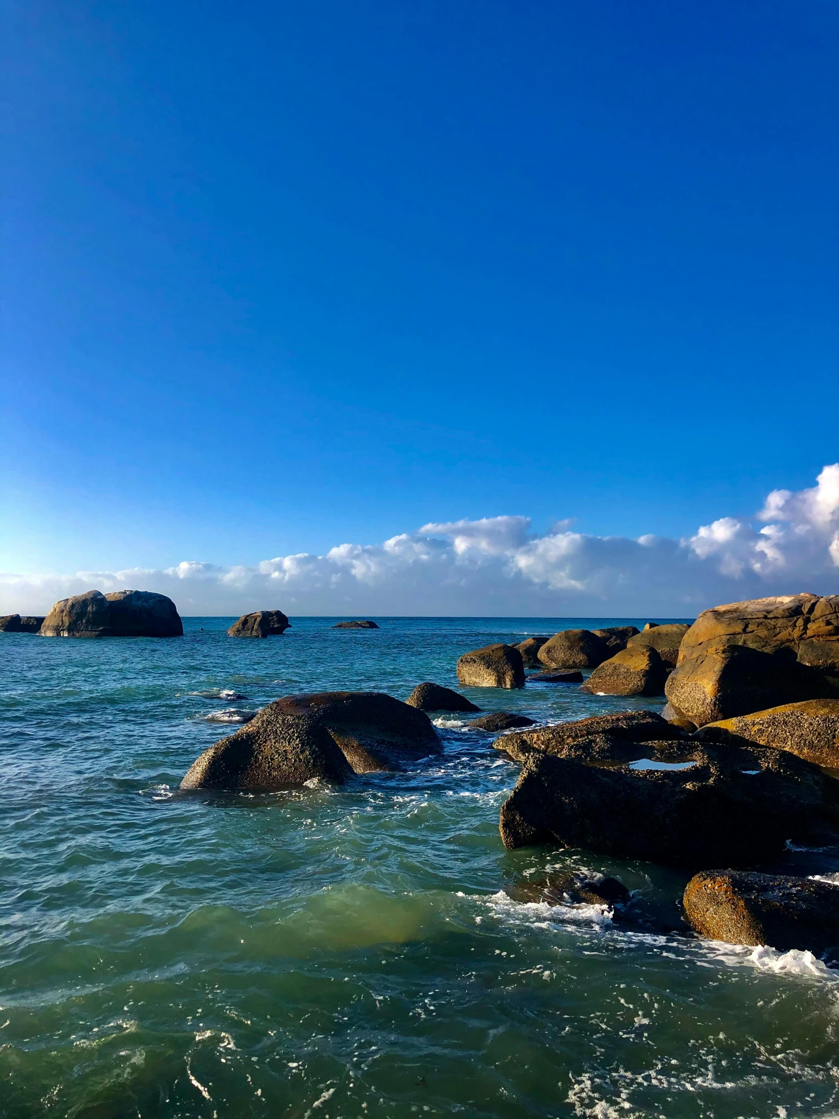 the rocky shoreline is near the ocean