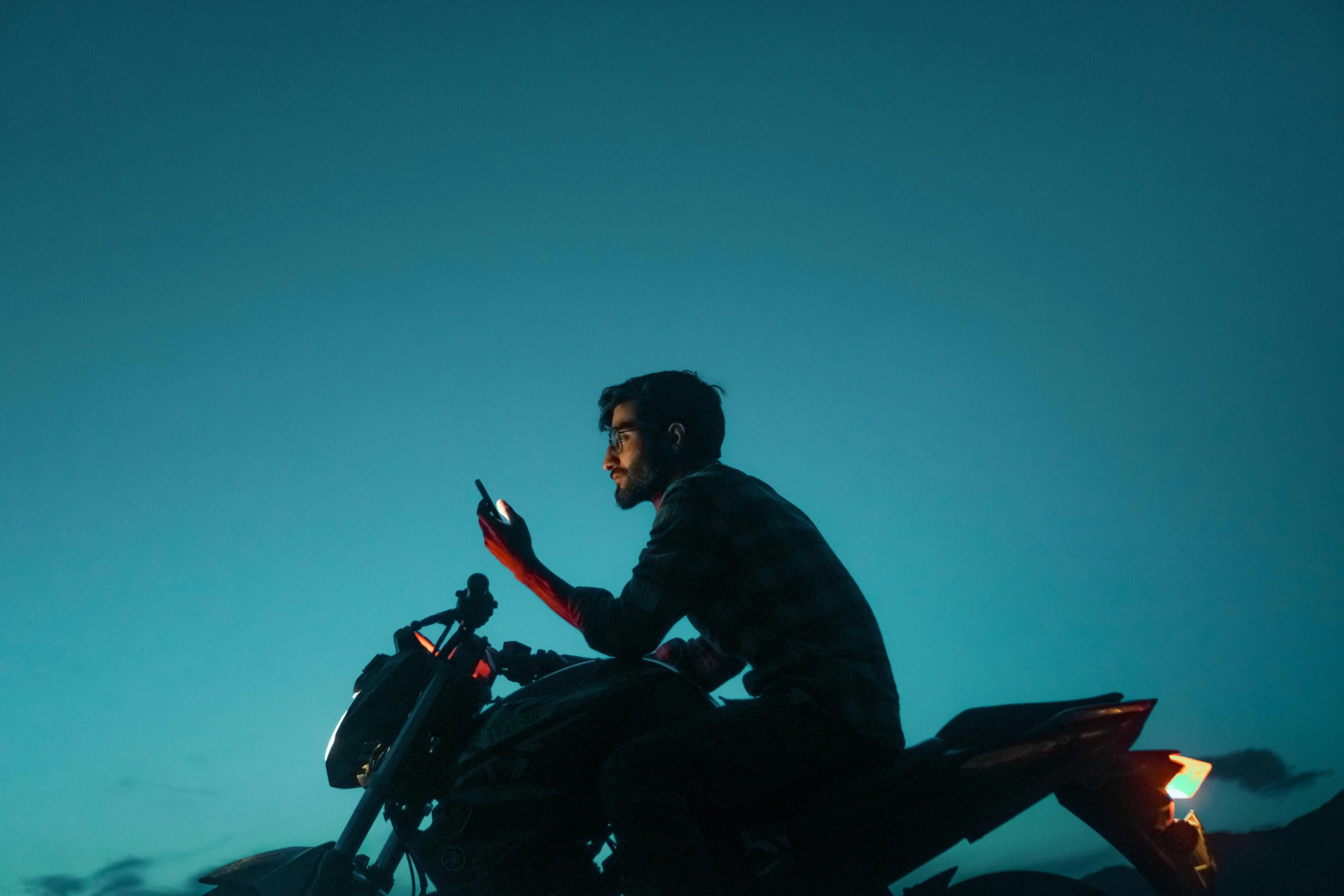 a man is riding on a motorcycle at night