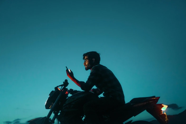 a man is riding on a motorcycle at night