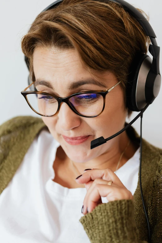 a woman wearing glasses has headphones to protect her ear