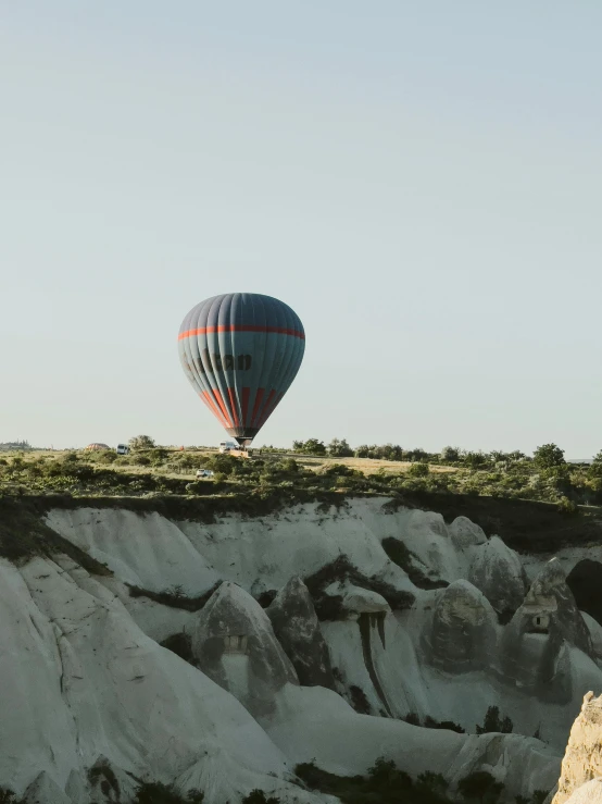 two  air balloons in the distance against a blue sky