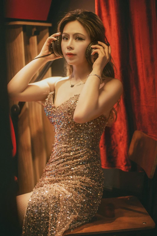 a woman wearing a very elegant gown talking on her phone