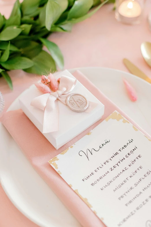 a wedding table is decorated with pink, white and gold items