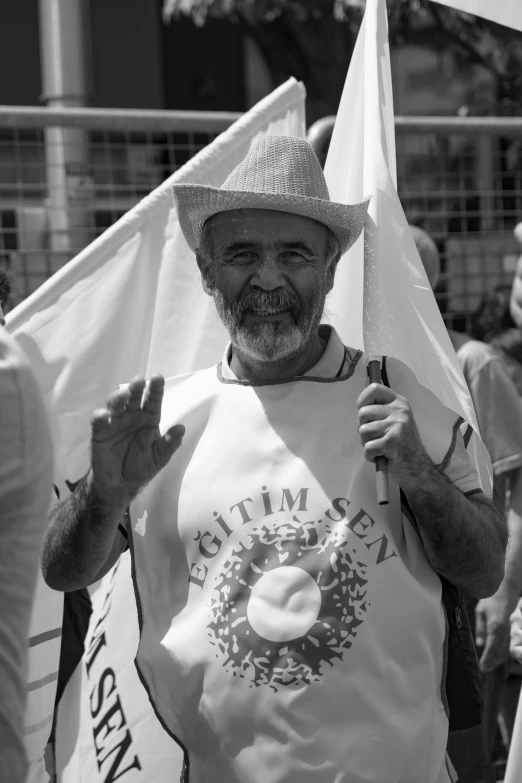 black and white po of an older man holding a plate and a flag