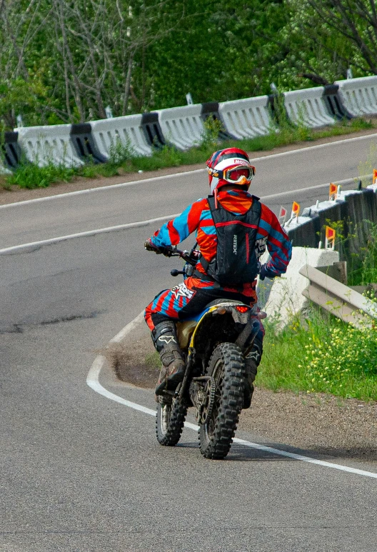 a man riding on the back of a dirt bike