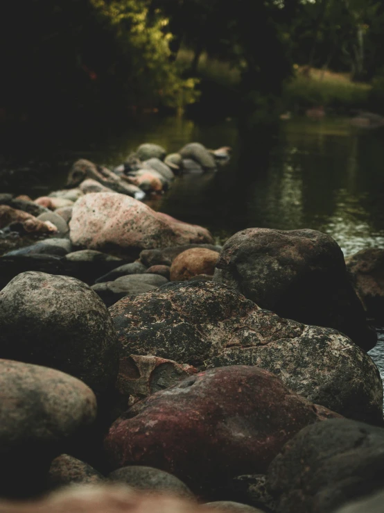 rocks near a body of water, with a small stream running between them