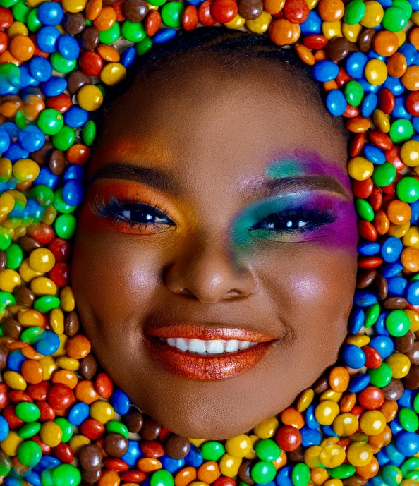 an image of a woman smiling surrounded by gumballs