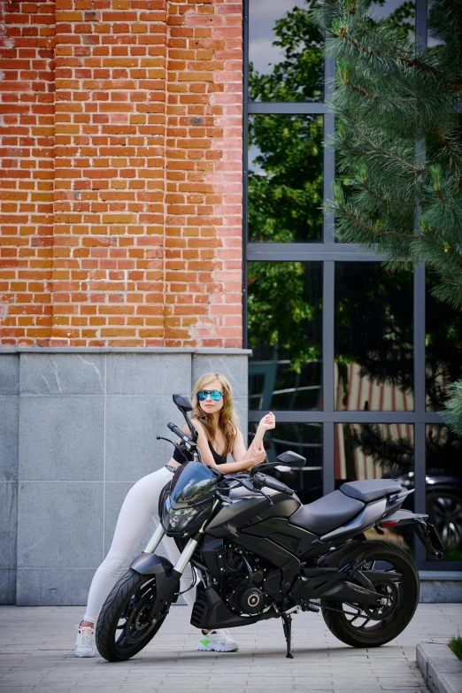 a woman sitting on top of a parked motorcycle