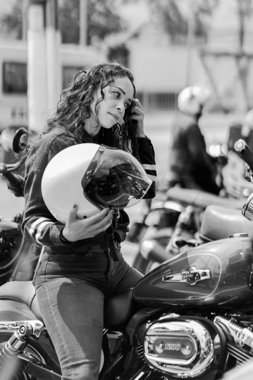 woman talking on a cellphone while sitting on motorcycle