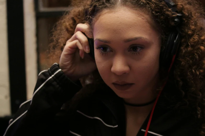 a woman wearing headphones looking at the camera