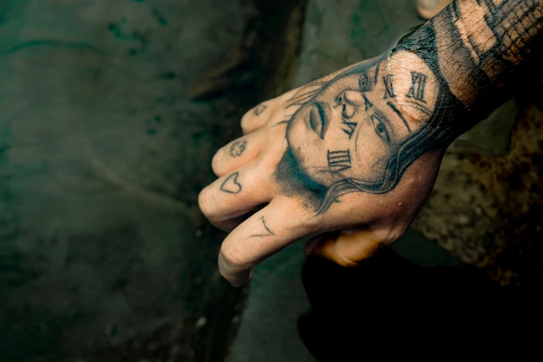 a person has some tattoos on their hand
