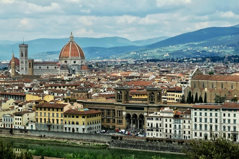 an aerial view of a city with the hills in the background