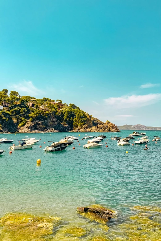 a harbor full of boats floating on the ocean