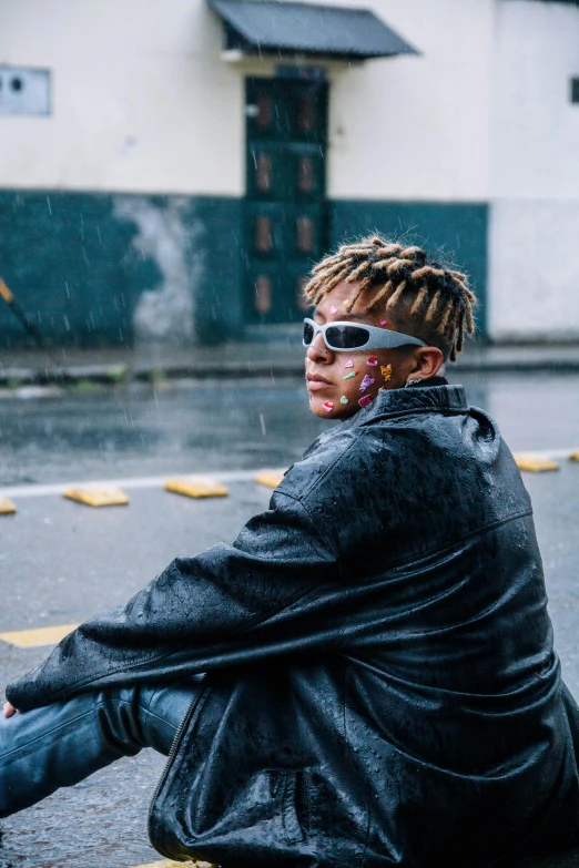 a person sitting on the ground in front of a building