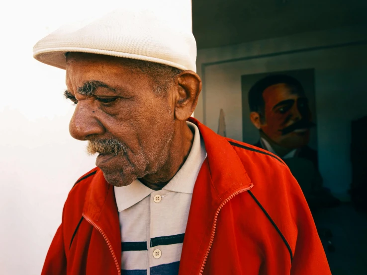 a man with a mustache looking down at the ground