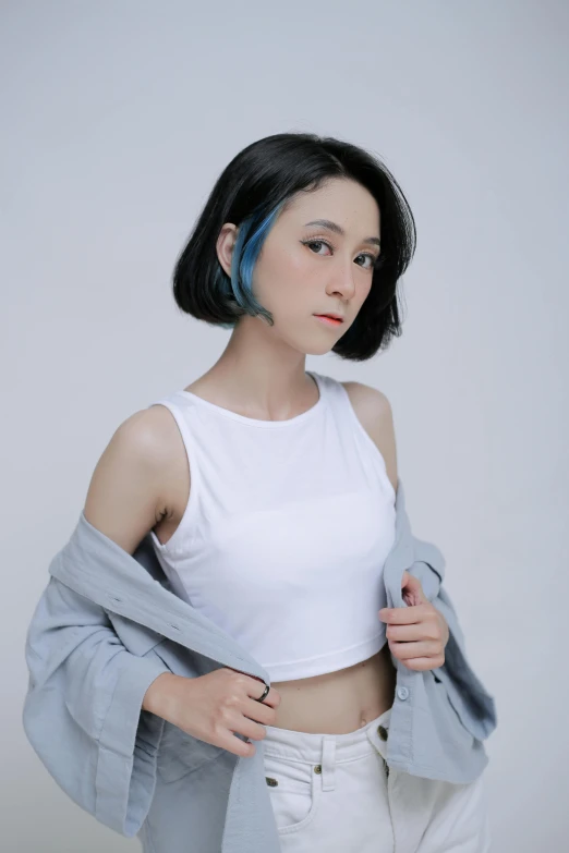 the young woman with short black hair is posing for the camera