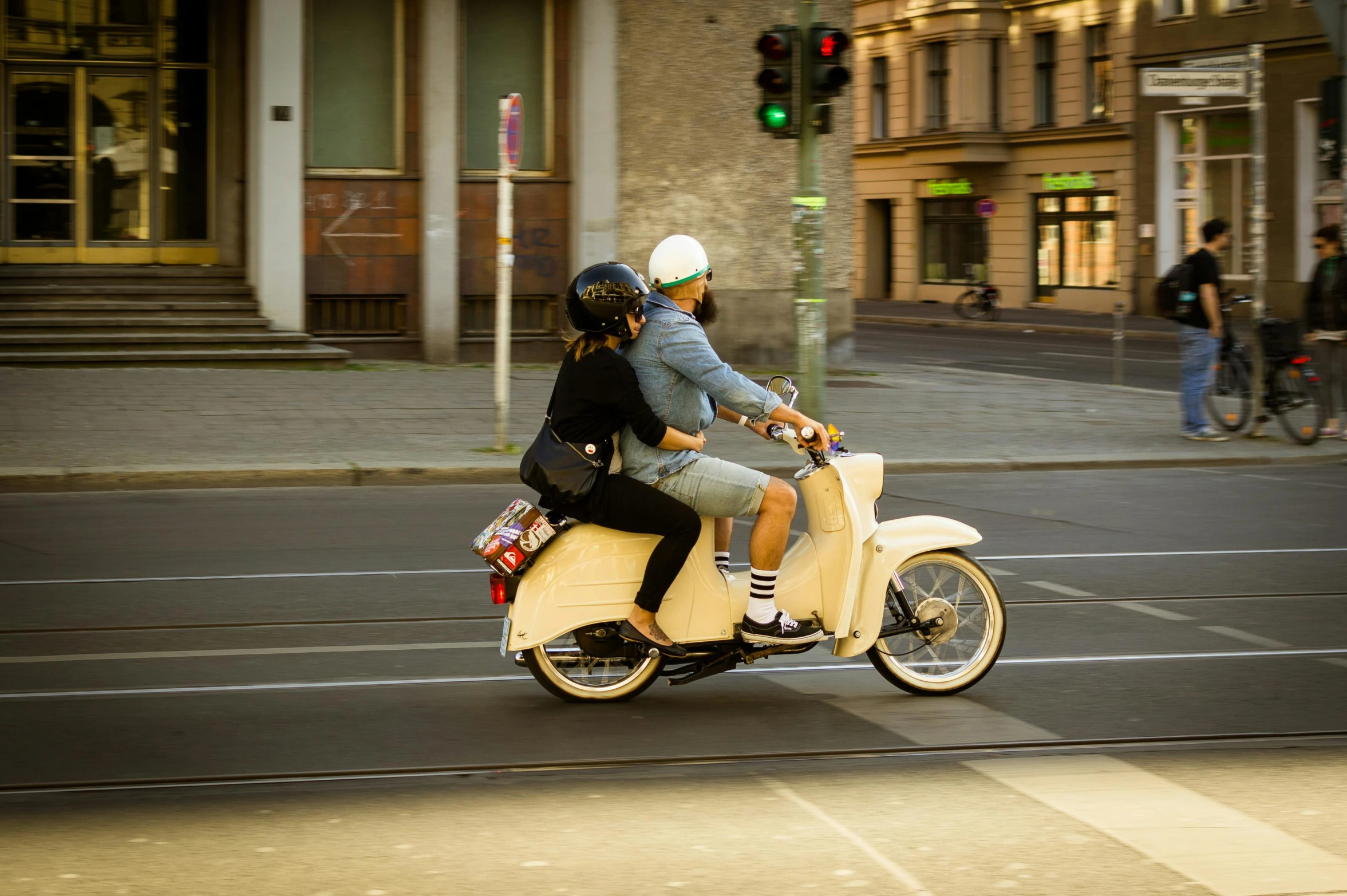 two people riding on the back of a motorcycle