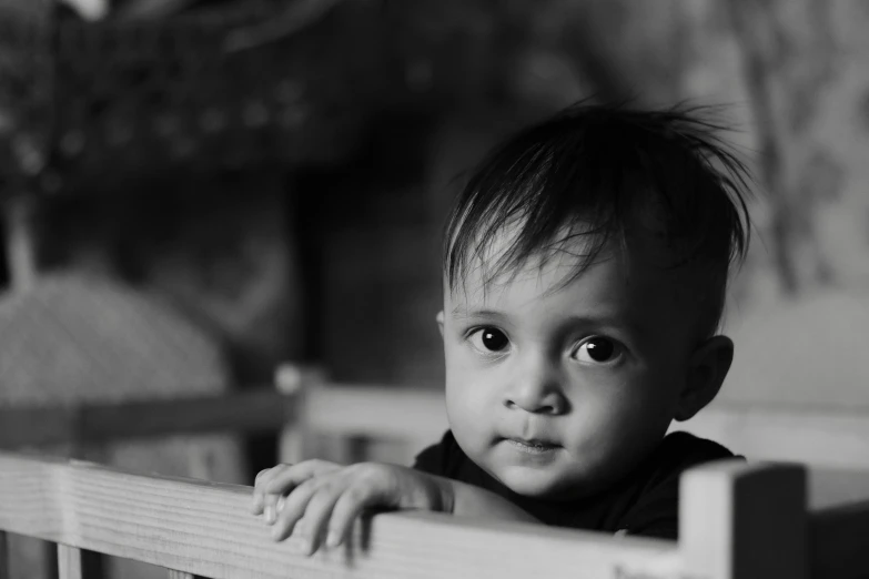 the young child is posing on his bed