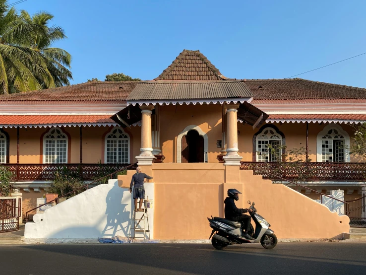 an orange house with large chimneys and a bike