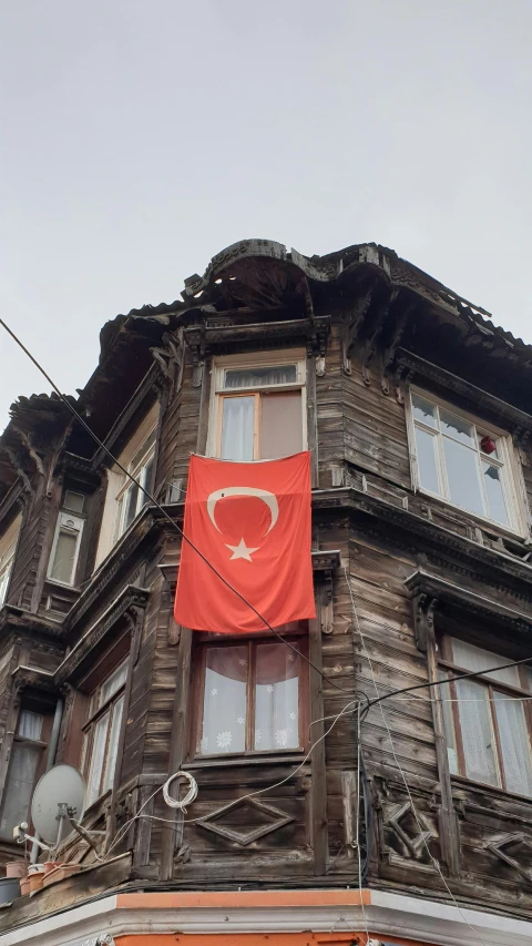 an old building that has a large flag on it